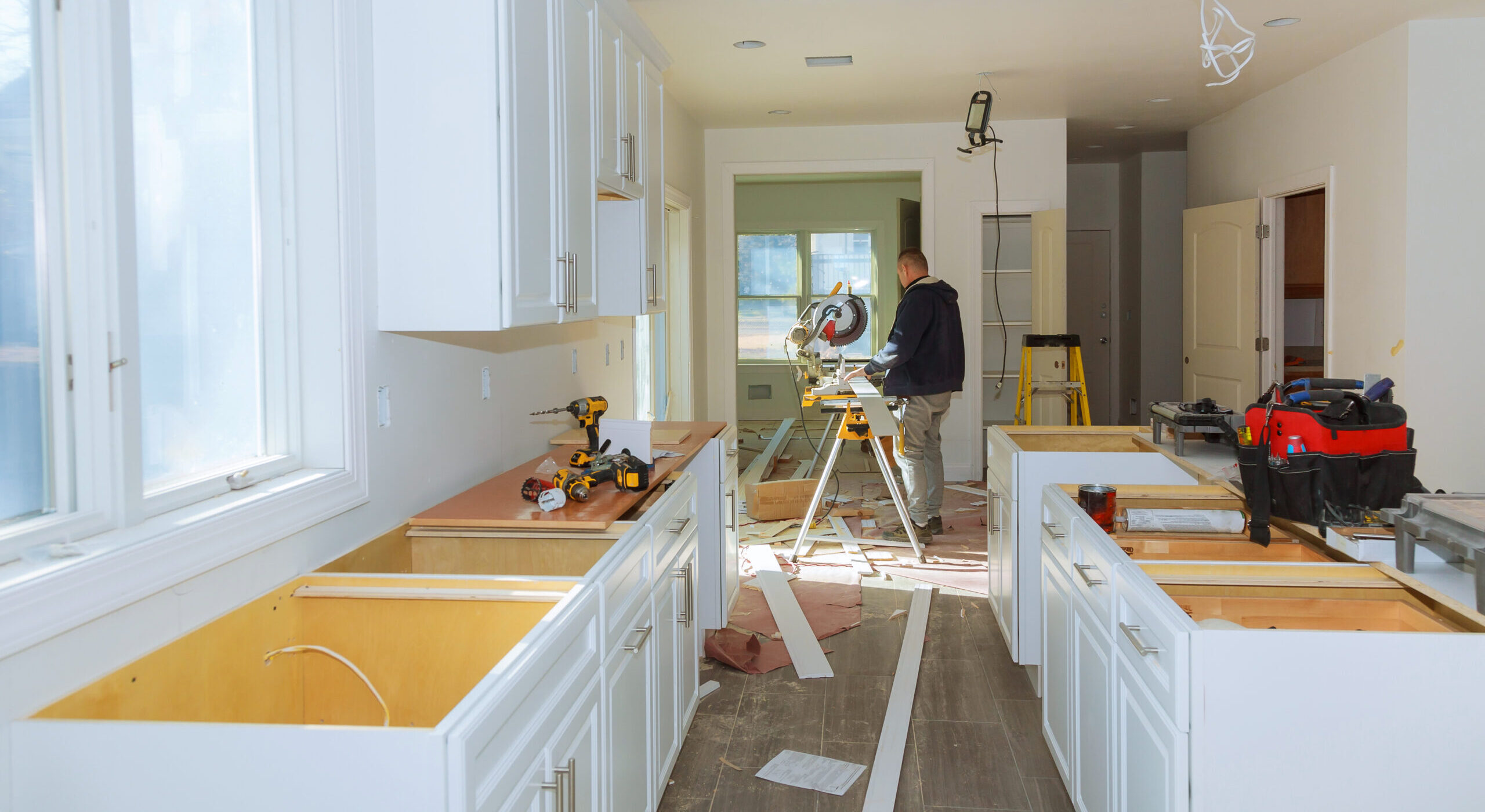 Contractor Using Circular Saw Cutting Crown Moulding for Renovation.